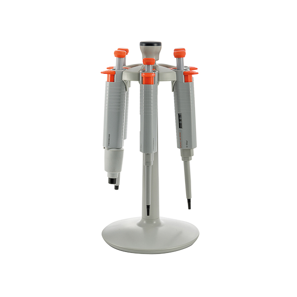 Precision laboratory micropipette stand with four adjustable pipettes for scientific research.